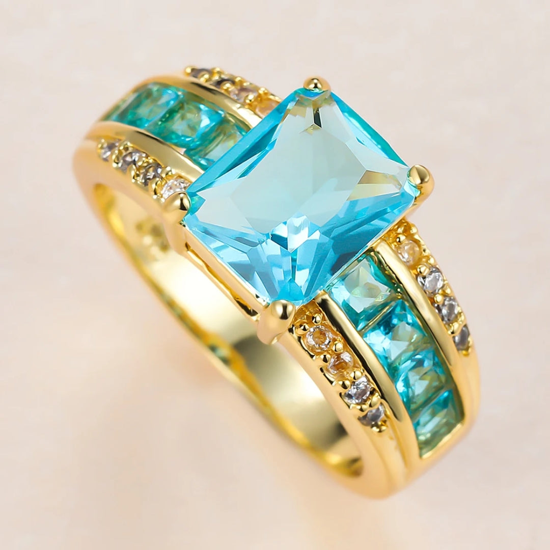 Gold Ring with Light Blue Crystal Accent