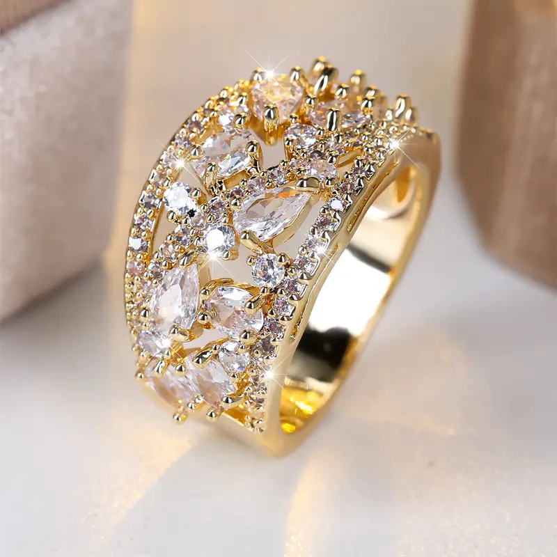 Gold Ring with Hollow Design and White Crystal Accents